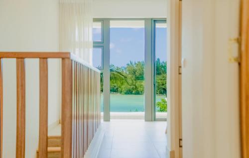 a hallway with a door open to a view of the ocean at Seafront apartment in Grande Gaube
