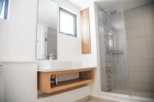 a bathroom with a sink and a shower at Seafront apartment in Grande Gaube