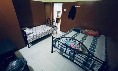 two twin beds in a room with at Foothill Lodge in Guwahati