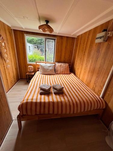 a bedroom with a bed with two towels on it at Ibiza style chalet in Eext