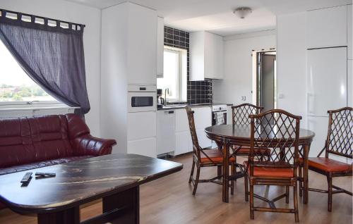 a living room with a couch and a table and chairs at 3 Bedroom Nice Apartment In Sölvesborg in Sölvesborg
