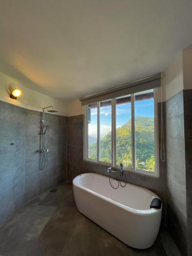 a large bath tub in a bathroom with a window at Crystal springs mount face Hotel in Ella