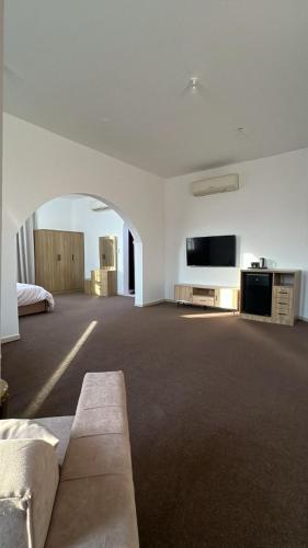 a large living room with a couch and a flat screen tv at Khalifa A Apartement V15 in Abu Dhabi