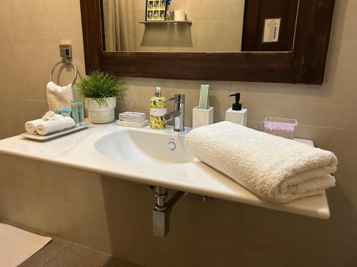 a bathroom sink with a white towel on it at The Manor 1926 in Colombo