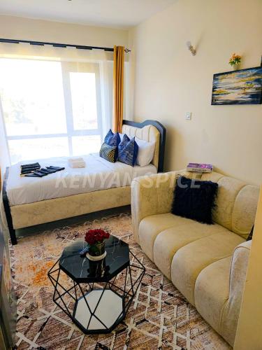 a living room with a couch and a bed at Bohen BnB 2 in Ongata Rongai 