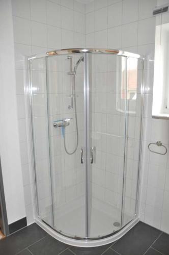 a shower with a glass door in a bathroom at Ferienhaus Lutowsee in Grammertin