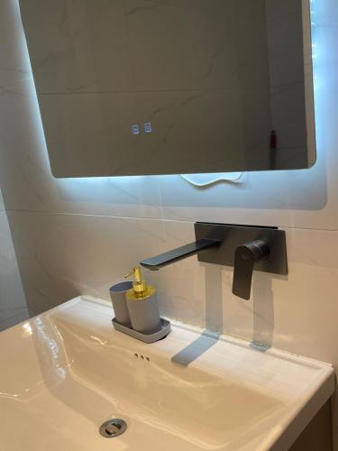 a bathroom sink with a mirror and a brush at Bellwether Heights Kyanja in Kampala