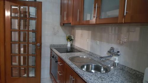a kitchen with a sink and a counter top at Vale Formoso Apartment in Porto