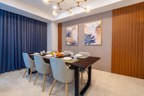 a dining room with a table and chairs at Morich Penthouse Jakarta in Jakarta