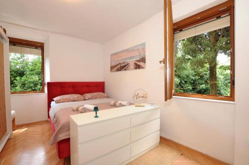 a bedroom with a bed and a dresser at HOLIDAY's HOUSE in Semedela
