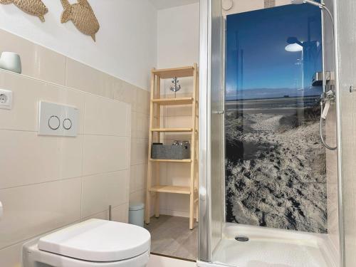a bathroom with a toilet and a glass shower at Villa Anna I - Wohnung Strandjunge in Sankt Peter-Ording
