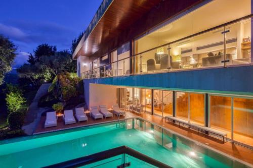 an image of a house with a swimming pool at Infinity Villa Cavez - Luxury Retreat in Moimenta