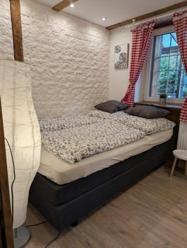 a bedroom with a bed with a window at Ferienhaus Schönek in Warmensteinach