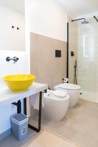 a bathroom with a sink and a toilet at Casale Santa Rosalia Charme Villas and Rooms in San Mauro Cilento