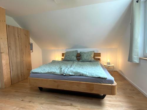 a bedroom with a bed with blue sheets and pillows at Schwedenhaus Fridhem mit Panoramablick auf dem Hügel in Monschau