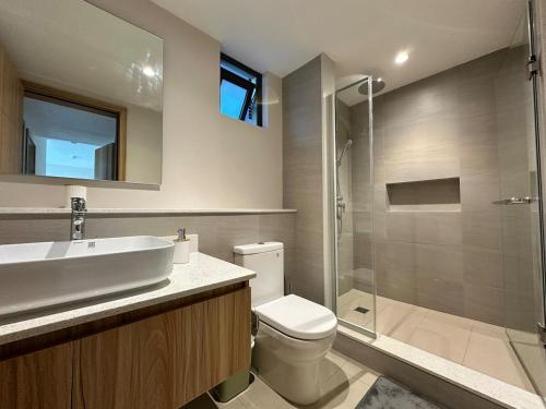a bathroom with a sink and a toilet and a shower at Verdant Horizon in Moka