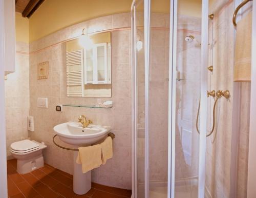 a bathroom with a toilet and a sink and a shower at B&B Puccini in Pescaglia