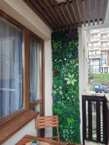 a green wall on the side of a house at Апартамент почивка в планината in Pamporovo