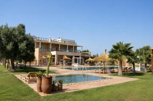 a resort with a swimming pool and a building at Riad SABIDI in Essaouira