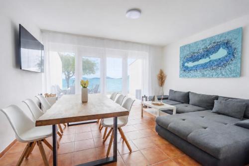 a living room with a couch and a table and chairs at BALATON A KERTBEN - BALATON IN THE GARDEN - Beachfront villas with beautiful view, private beach in Balatonfenyves
