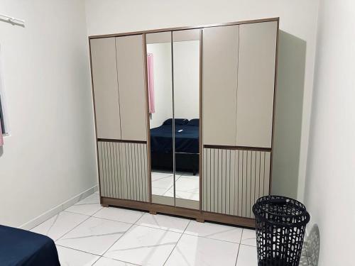 a wardrobe in a room with a bed in it at Recanto JF in Pirapora