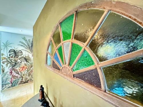 a window in a building with a painting on the wall at Les Roses de Montherlant in Montherlant