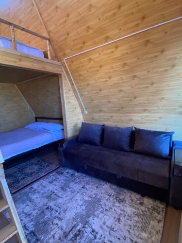 a small room with a couch and bunk beds at Baet Home in Bayetovka