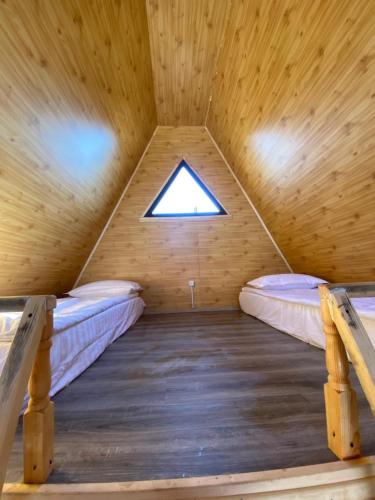 a room in a wooden cabin with two bunk beds at Baet Home in Bayetovka