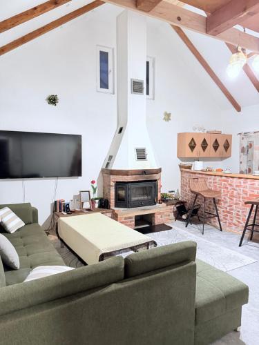 a living room with two couches and a fireplace at VikendicaDM in Hrvačići