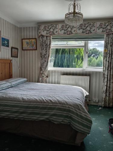 a bedroom with a bed and a window at Room with a View in Grantham