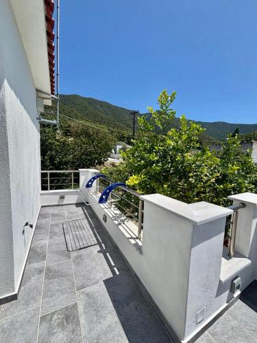 a white balcony with a view of a mountain at Elios Serenity House in Neo Klima