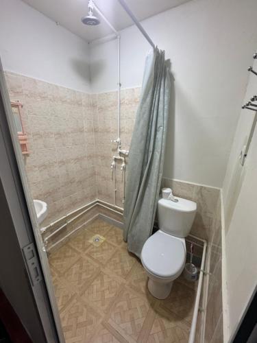 a bathroom with a toilet and a shower at Sharsharai Haftkul in Panjakent