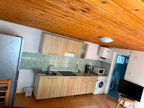 a kitchen with a sink and a microwave at Casa Baciului,Cluj-Napoca in Cluj-Napoca