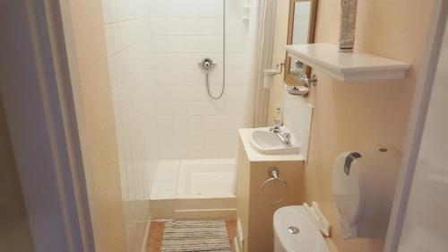 a bathroom with a shower and a toilet and a sink at Hornby House Hotel in Blackpool