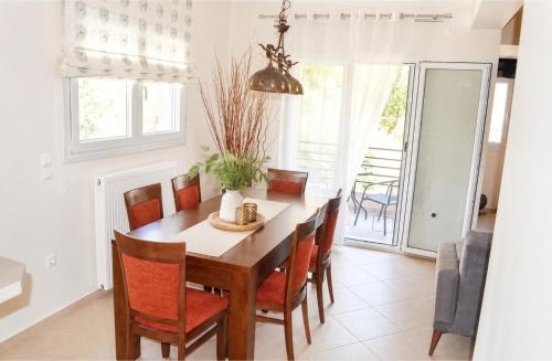 a dining room with a table and chairs at Holiday Lefkas Moonlight Luxury Appartments in Nikiana