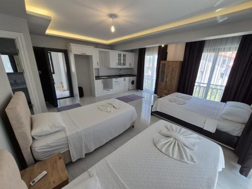 a hotel room with two beds and a kitchen at Villa Kaya Maris Göcek in Fethiye