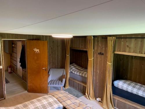 a room with two bunk beds in a house at Nordgården in Handeland