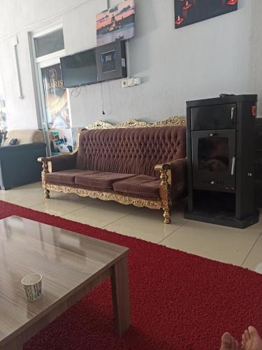 a living room with a couch and a fireplace at Barış hotel in Alasehir