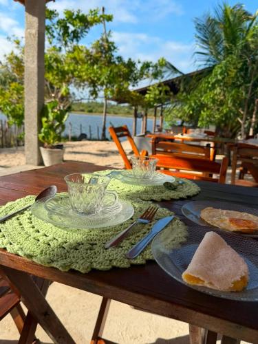 a wooden table with a plate of food on it at Chalé Brisa da Lagoa in Icaraí