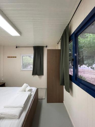 a small room with a bed and a window at Seaside Garden Galaxidi in Galaxidi