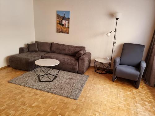 a living room with a couch and a chair at Tinas Ferienwohnung in Kröv