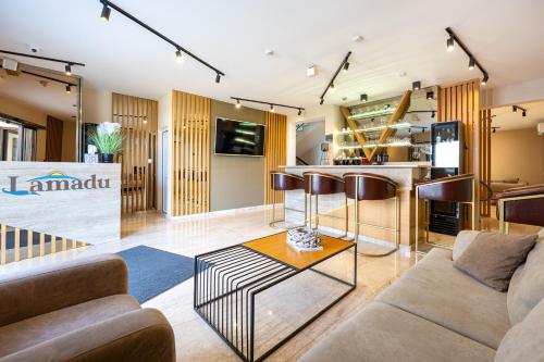 a living room with a couch and a kitchen at Lamadu Residence in Sutomore