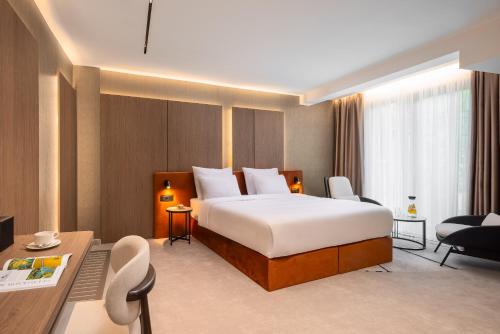 a hotel room with a bed and a desk at PLATINUM hotel & spa in Sarajevo