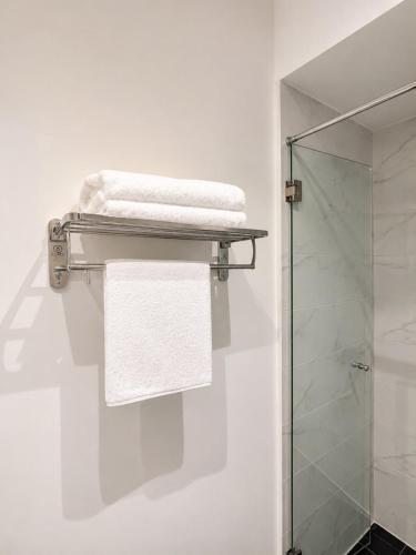 a towel rack in a bathroom with a shower at EMBASSY - Sky Suites in Accra