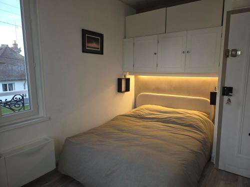 a bed in a room with a window at Charmant studio le Crotoy in Le Crotoy