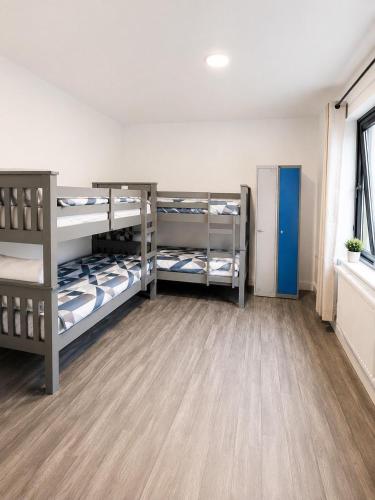 a room with three bunk beds in a room at The Central Dublin Hostel in Dublin