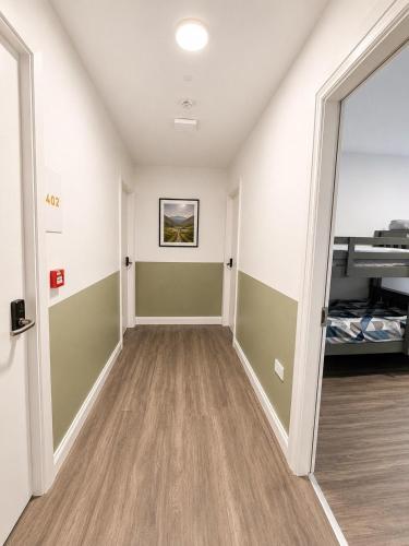 an empty room with a hallway with a bed at The Central Dublin Hostel in Dublin