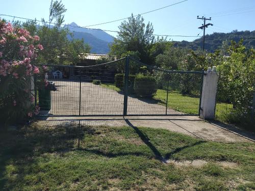 a gate in a yard with a driveway at Efterpi seaside house in Chrysi Ammoudia