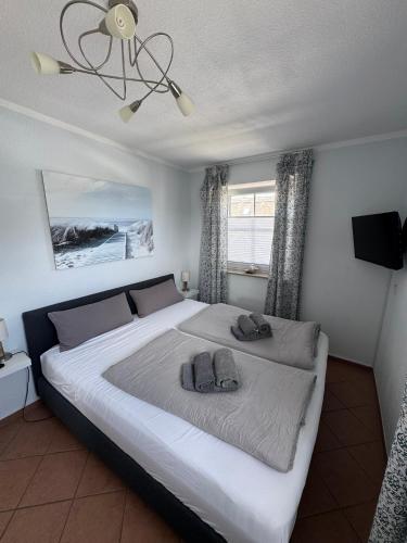 a bedroom with a large bed with two towels on it at Möwennest 13 Scharbeutz in Scharbeutz