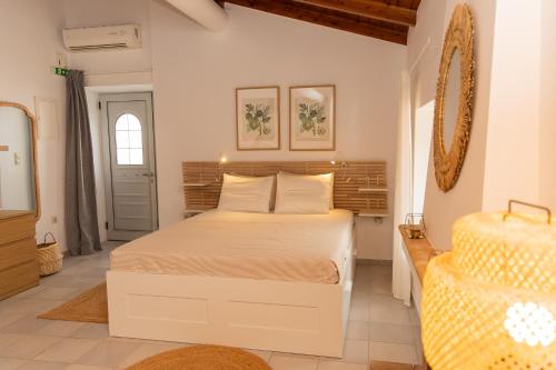 a bedroom with a large white bed in a room at Emerald Courtyard House in Kranidi